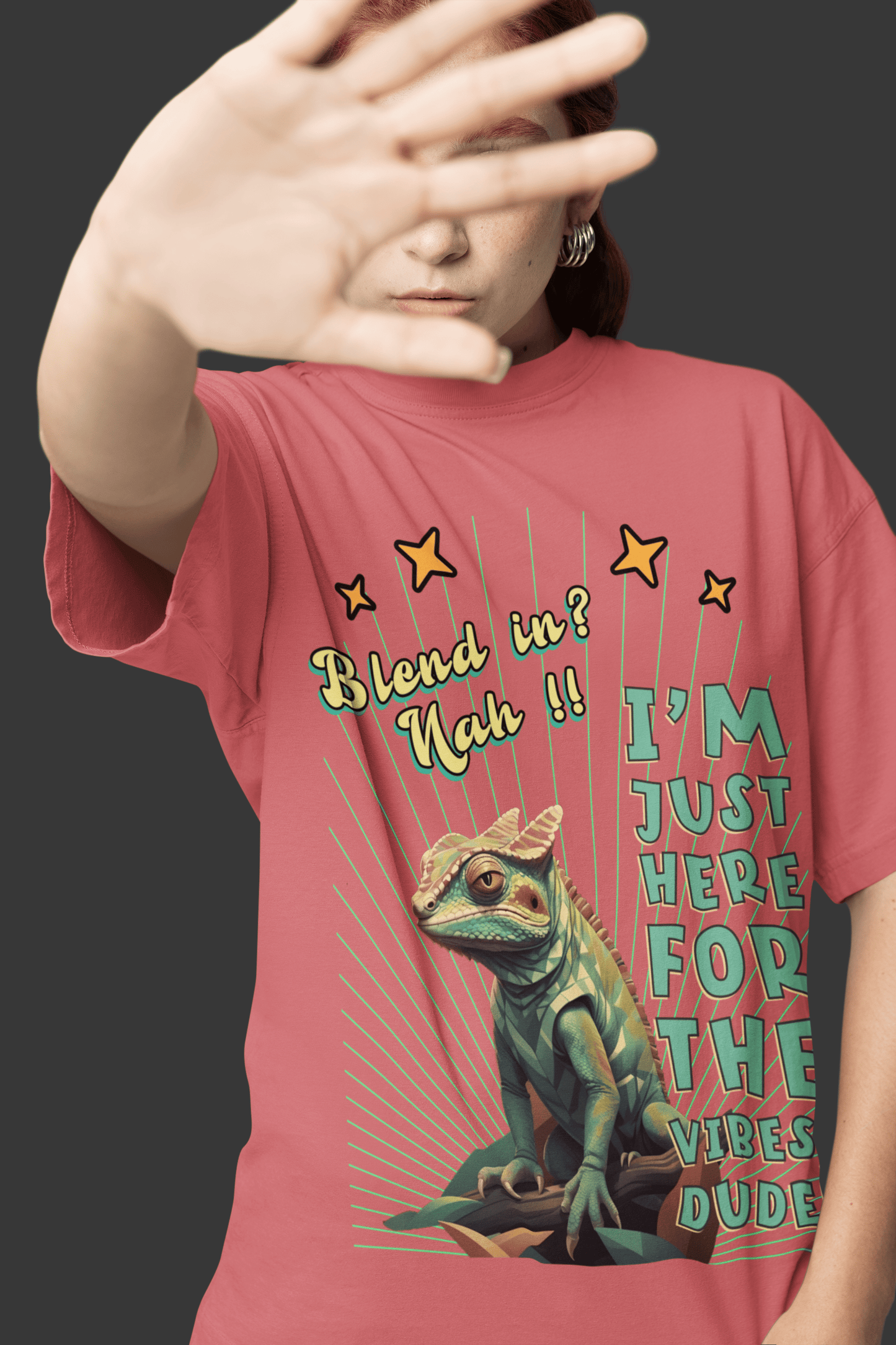 Woman holding her hand in front of her face, wearing a 'Blend in? Nah!! I'm just here for the vibes, dude!' T-shirt